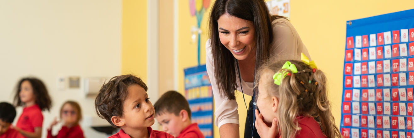 Happy teacher and student looking at each other