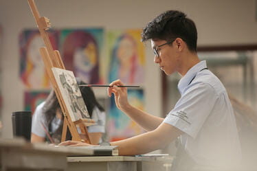 Student painting onto a Canvas