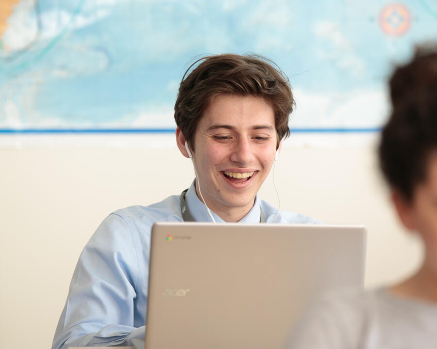 A Teacher seated at a desk