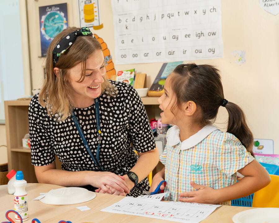 Student and Teacher sat at a table